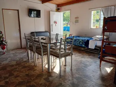 a room with a table and chairs and a bed at La grina in Bialet Massé
