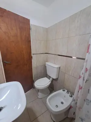 a small bathroom with a toilet and a sink at Adonay in Mina Clavero