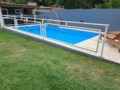 a metal deck with a blue swimming pool at Adonay in Mina Clavero