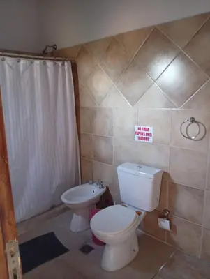 a bathroom with a toilet and a sink at Cabañas La Bahia Escondida in Potrero de Garay