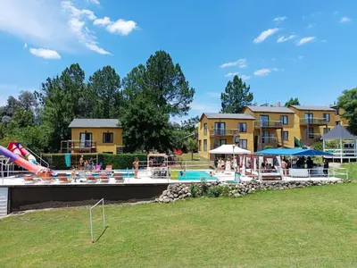 a pool at a resort with people standing around it at Cabañas La Bahia Escondida in Potrero de Garay