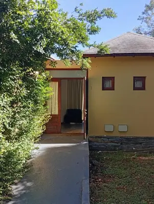 a house with a door and a couch in front of it at Cabañas La Bahia Escondida in Potrero de Garay