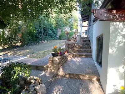 a stairway leading up to a house with some flowers at Espacio de relax in Trapiche