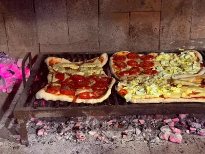 three pizzas sitting on top of a grill at Can,19,Anisacate in Villa Anizacate