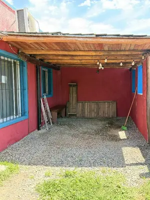 a wooden pergola on the side of a building at Can,19,Anisacate in Villa Anizacate
