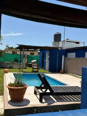 a pool with a hammock and a chair next to it at Can,19,Anisacate in Villa Anizacate