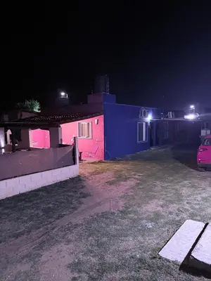 a house with pink and blue walls at night at Can,19,Anisacate in Villa Anizacate