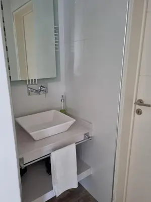 a bathroom with a white sink and a mirror at Cabañas NUEVA VIDA in Merlo