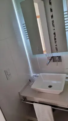 a bathroom with a sink and a mirror at Cabañas NUEVA VIDA in Merlo