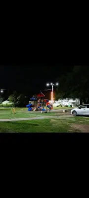 a park with a playground at night with a car at Crespi in San Lorenzo