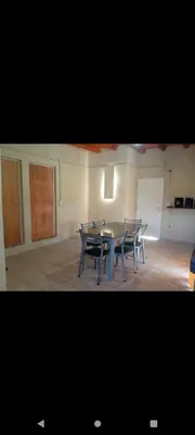 a dining room with a table and chairs in a room at Crespi in San Lorenzo