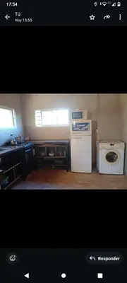 a kitchen with a stove and a washing machine at Crespi in San Lorenzo