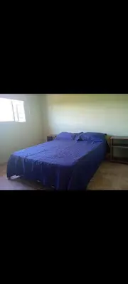a blue bed in a bedroom with a window at Crespito in San Lorenzo