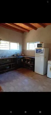 a kitchen with a white refrigerator and a sink at Crespito in San Lorenzo