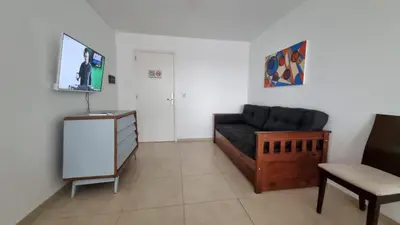 a living room with a couch and a tv at Departamento a Pasos de la Terminal y Hospitales in Cordoba