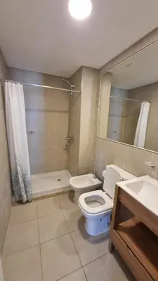 a bathroom with a toilet and a shower and a sink at Departamento a Pasos de la Terminal y Hospitales in Cordoba