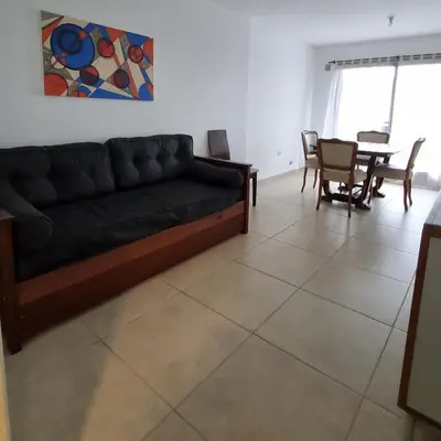 a living room with a couch and a table at Departamento a Pasos de la Terminal y Hospitales in Cordoba