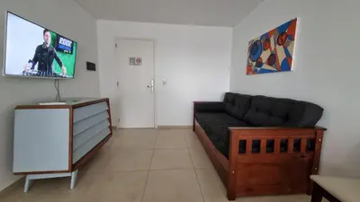 a living room with a couch and a flat screen tv at Departamento a Pasos de la Terminal y Hospitales in Cordoba