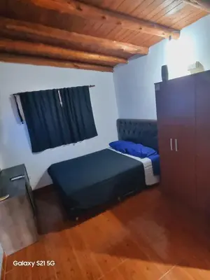 a small room with a bed and a window at Departamento mina clavero in Mina Clavero