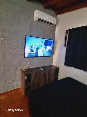 a room with a flat screen tv on a wall at Departamento mina clavero in Mina Clavero