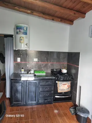 a kitchen with a stove and a sink at Departamento mina clavero in Mina Clavero