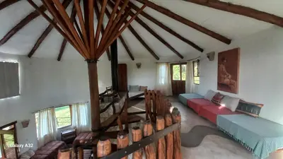a living room with a couch and chairs in it at Cabañas Bendita Tierra 1 in Los Molles