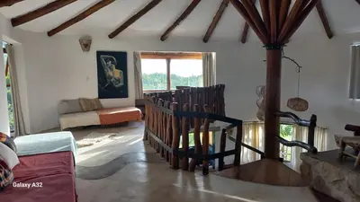 a living room with a staircase and a couch at Cabañas Bendita Tierra 1 in Los Molles
