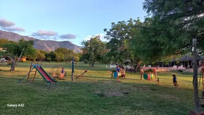 a group of children playing in a park at Cabañas Bendita Tierra 1 in Los Molles
