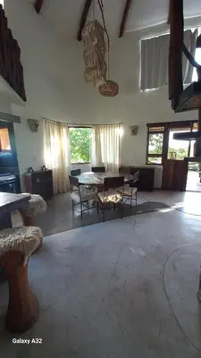 a large living room with a table and chairs at Cabañas Bendita Tierra 1 in Los Molles
