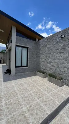 a brick building with a patio in front of it at Casita Champaqui in Villa de Las Rosas