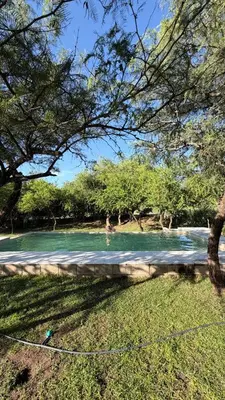 a person in the water in a swimming pool at Casita Champaqui in Villa de Las Rosas