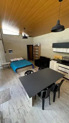 a room with a table and a bed at Casita Champaqui in Villa de Las Rosas