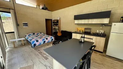 a kitchen with a table and a bed in a room at Casita Champaqui in Villa de Las Rosas
