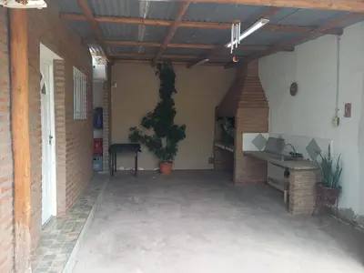 an empty garage with a table and a plant at Apartamentos Las Margaritas in Villa Santa Cruz del Lago