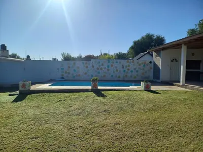 a backyard with a swimming pool and a fence at Apartamentos Las Margaritas in Villa Santa Cruz del Lago