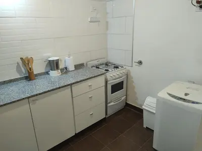 a white kitchen with a stove and a sink at Las Toribias II in El Rincón