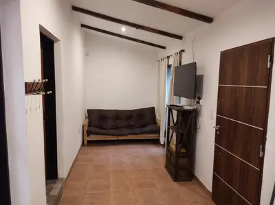 a living room with a couch and a television at Las Toribias II in El Rincón