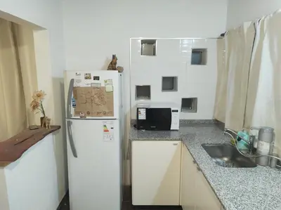 a kitchen with a white refrigerator and a sink at Las Toribias II in El Rincón