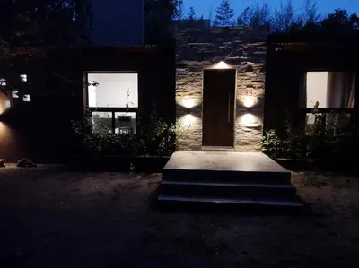 a house with a door and lights in the dark at Las Toribias II in El Rincón