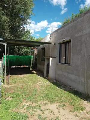 a building with a green covering on the side of it at Bustos-Ariza in Villa Cura Brochero
