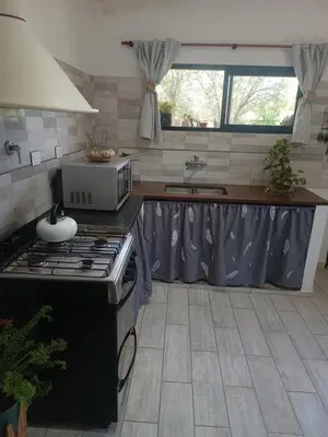 a kitchen with a stove and a counter top at Bustos-Ariza in Villa Cura Brochero