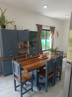 a kitchen with a wooden table and blue cabinets at Bustos-Ariza in Villa Cura Brochero
