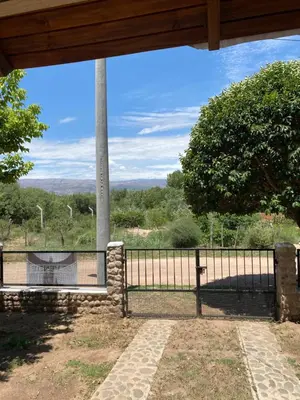 a gate with a view of a field at Casa Mi Sueño in Villa Cura Brochero
