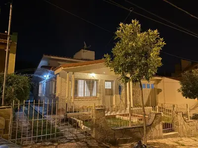a house with a fence in front of it at night at Chalet Ferrari in Mina Clavero