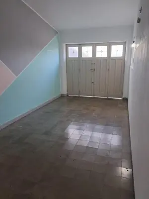 an empty room with doors and a tile floor at Chalet Ferrari in Mina Clavero