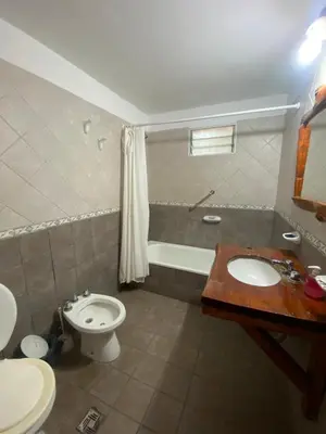 a bathroom with a sink and a toilet and a tub at Portal del Bosque in Villa Ciudad Parque