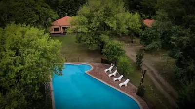 an overhead view of a swimming pool with two lounge chairs at Portal del Bosque in Villa Ciudad Parque