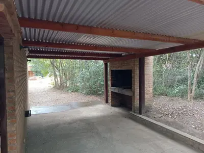 a brick garage with awning and a brick fireplace at Portal del Bosque in Villa Ciudad Parque
