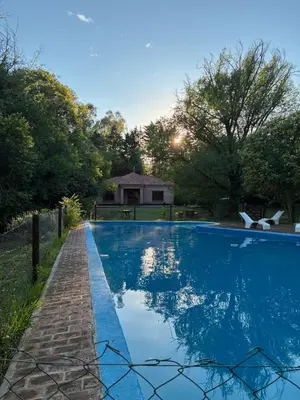 a swimming pool in a yard with a house at Portal del Bosque in Villa Ciudad Parque