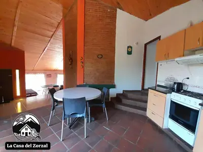 a kitchen and dining room with a table and chairs at La Casa del Zorzal in San Antonio de Arredondo